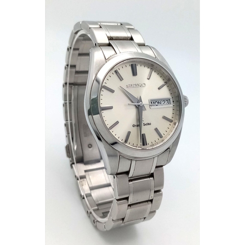 176 - A Vintage Grand Seiko Quartz Gents Watch. Stainless steel bracelet and case - 37mm. Silver tone dial... 