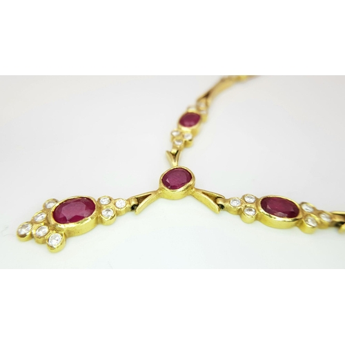 259 - A Gorgeous 18K Yellow Gold Ruby and Diamond Necklace. Arrowhead links sit amongst six oval rubies an... 