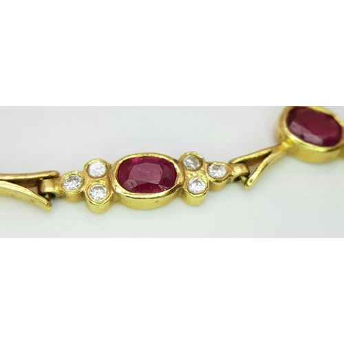 259 - A Gorgeous 18K Yellow Gold Ruby and Diamond Necklace. Arrowhead links sit amongst six oval rubies an... 