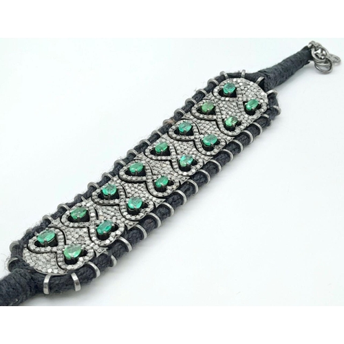 297 - A beautifully handcrafted bracelet embossed with  approx 6.10ct diamonds and 7.20cts Emeralds, set i... 