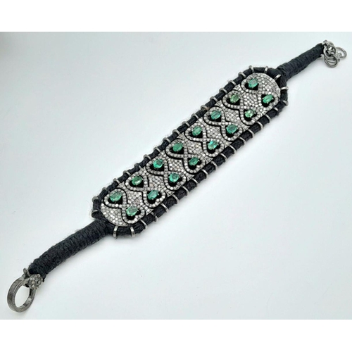 297 - A beautifully handcrafted bracelet embossed with  approx 6.10ct diamonds and 7.20cts Emeralds, set i... 