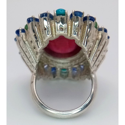 304 - A 925 silver ring with a 15ct central ruby, accented by 12ct opals and 1.50ct diamonds. Ring size O.... 