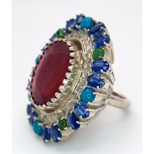 304 - A 925 silver ring with a 15ct central ruby, accented by 12ct opals and 1.50ct diamonds. Ring size O.... 