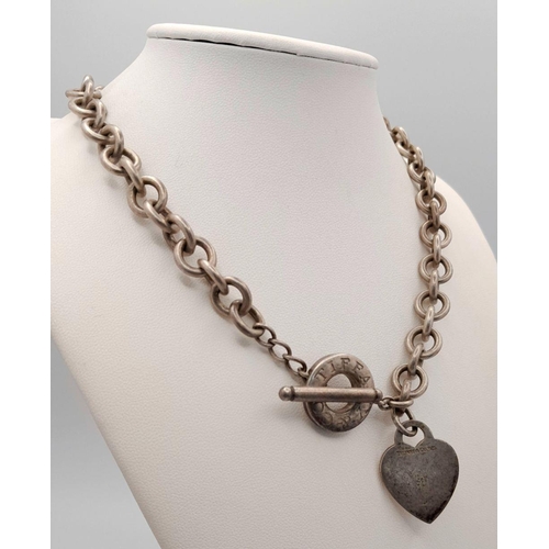 451 - A Tiffany and Co. Sterling Silver Chain with Toggle Clasp and Heart Charm. 36cm. 76g weight.