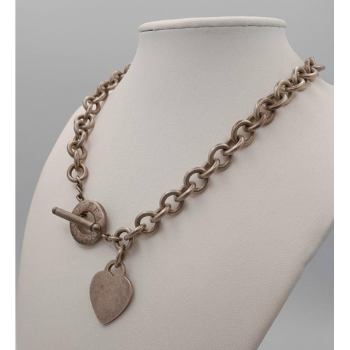 451 - A Tiffany and Co. Sterling Silver Chain with Toggle Clasp and Heart Charm. 36cm. 76g weight.