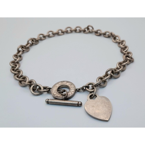 451 - A Tiffany and Co. Sterling Silver Chain with Toggle Clasp and Heart Charm. 36cm. 76g weight.