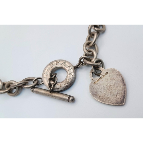 451 - A Tiffany and Co. Sterling Silver Chain with Toggle Clasp and Heart Charm. 36cm. 76g weight.