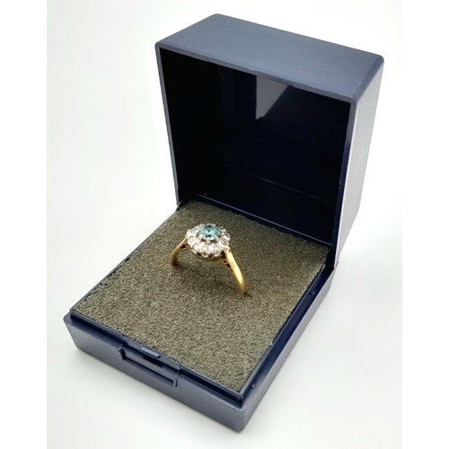 581 - An elegant vintage 18 carat GOLD,  sparkling AQUAMARINE and DIAMOND RING. Having a round cut AQUAMAR... 