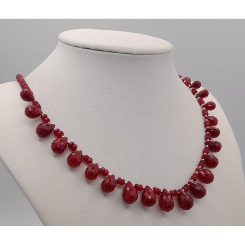 614 - A 925 silver single strand necklace with 100ct ruby gemstone drops and ruby beads, finished with a s... 