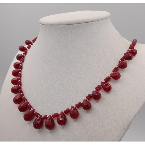 614 - A 925 silver single strand necklace with 100ct ruby gemstone drops and ruby beads, finished with a s... 