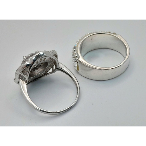 644 - 2 x STUNNING SILVER and ZIRCONIA CLUSTER RINGS. Complete with ring boxes. Both Rings Size L 1/2.  Fl... 