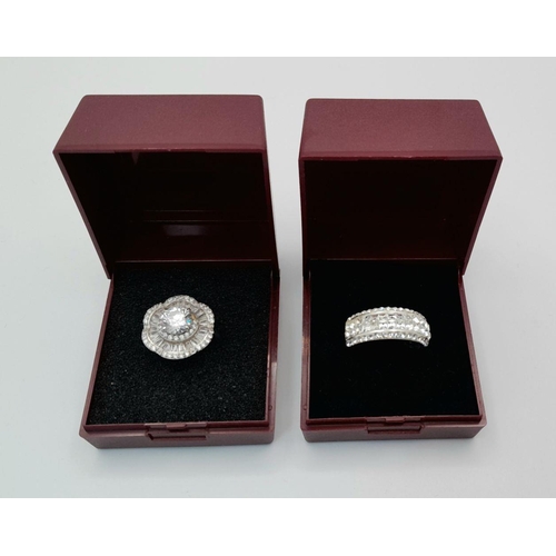 644 - 2 x STUNNING SILVER and ZIRCONIA CLUSTER RINGS. Complete with ring boxes. Both Rings Size L 1/2.  Fl... 