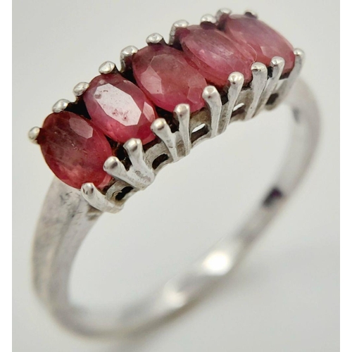 665 - Impressive SILVER and RUBY RING. Having a sweep of 5 x individually mounted RUBIES set to top. Marki... 