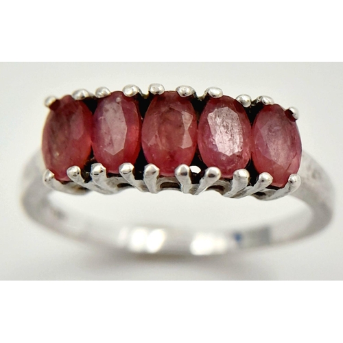 665 - Impressive SILVER and RUBY RING. Having a sweep of 5 x individually mounted RUBIES set to top. Marki... 