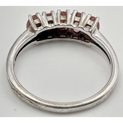 665 - Impressive SILVER and RUBY RING. Having a sweep of 5 x individually mounted RUBIES set to top. Marki... 