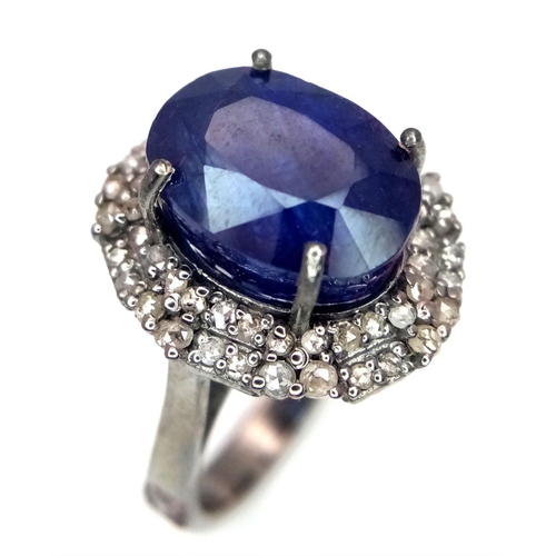 668 - A 925 silver ring with a 10.15ct blue sapphire and 0.75ct diamond accents. Ring size M. Comes with a... 