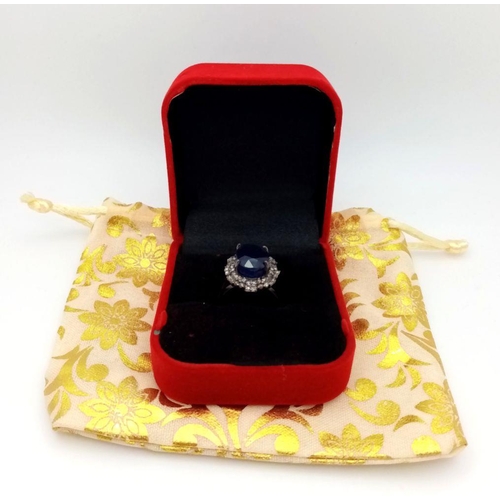 668 - A 925 silver ring with a 10.15ct blue sapphire and 0.75ct diamond accents. Ring size M. Comes with a... 