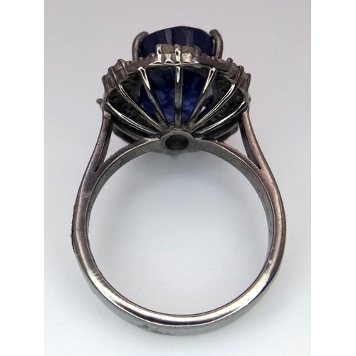 668 - A 925 silver ring with a 10.15ct blue sapphire and 0.75ct diamond accents. Ring size M. Comes with a... 