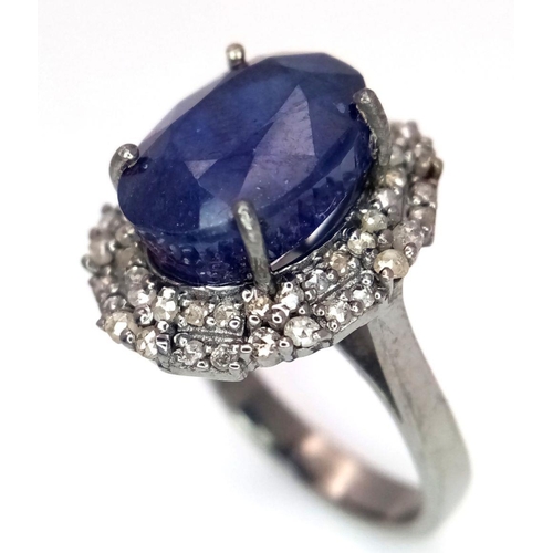 668 - A 925 silver ring with a 10.15ct blue sapphire and 0.75ct diamond accents. Ring size M. Comes with a... 