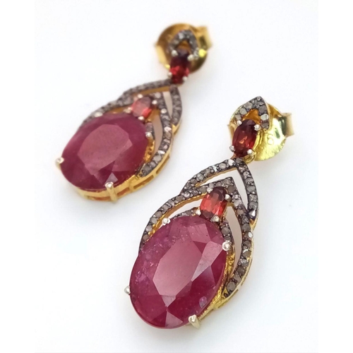 675 - A pair of 925 silver earrings with 9ct rubies and 0.60ct diamond accents, finished in yellow silver.... 