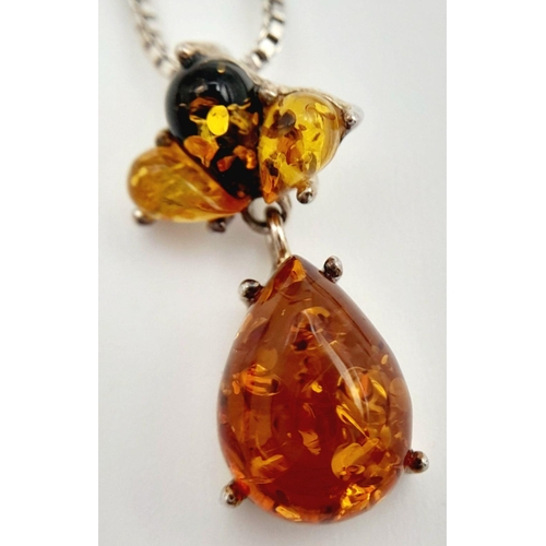 700 - A ‘HOBBS’  AMBER and SILVER PENDANT. Having different shades of Amber set in SILVER and mounted on a... 