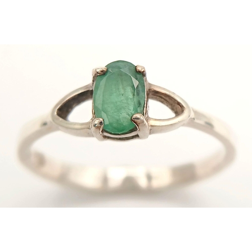 817 - A Sterling Silver and Emerald Solitaire Ring Size N. The Ring is set with a 6mm Oval Cut Emerald and... 