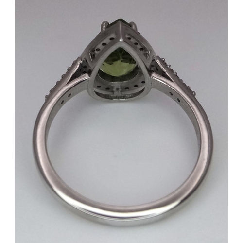 955 - A 925 silver ring with a pear-cut 2.5ct peridot gemstone and 0.40ct diamond accents. Ring size O. Co... 