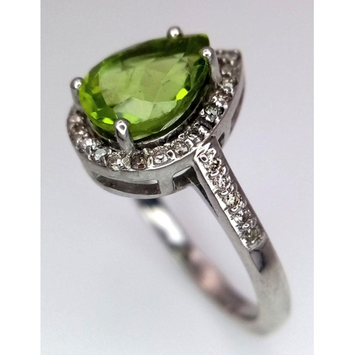 955 - A 925 silver ring with a pear-cut 2.5ct peridot gemstone and 0.40ct diamond accents. Ring size O. Co... 