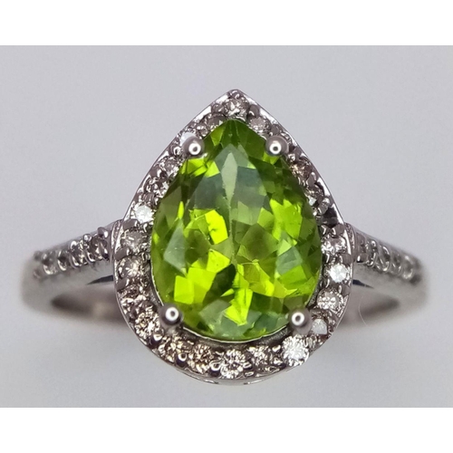 955 - A 925 silver ring with a pear-cut 2.5ct peridot gemstone and 0.40ct diamond accents. Ring size O. Co... 