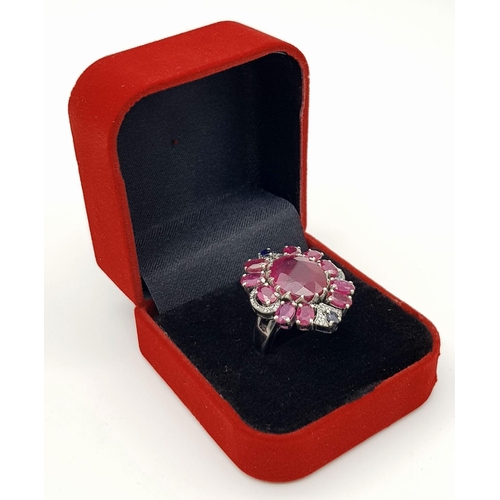 635 - A 925 silver ring with ruby and diamond accents surrounded, in floral design. 15ct Ruby , 0.40ct Dia... 