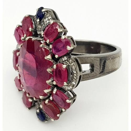 635 - A 925 silver ring with ruby and diamond accents surrounded, in floral design. 15ct Ruby , 0.40ct Dia... 