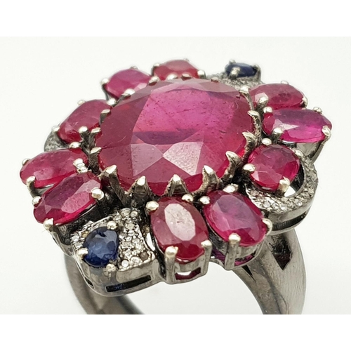 635 - A 925 silver ring with ruby and diamond accents surrounded, in floral design. 15ct Ruby , 0.40ct Dia... 