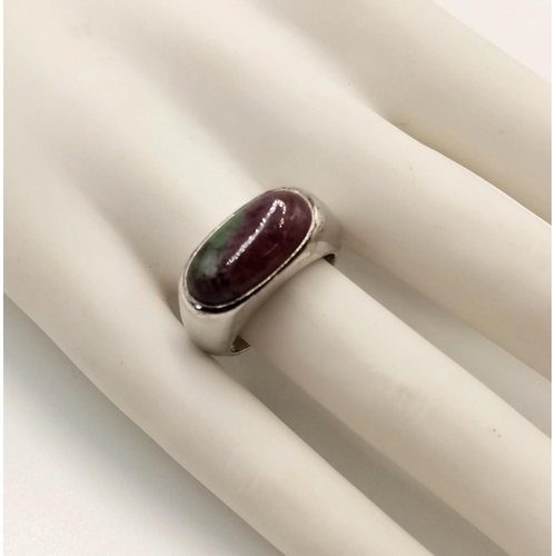 831 - A Modernist Design, Sterling Silver, Ruby in Zoisite Set Ring Size P. Set with a 1.8cm Oval Cut Ruby... 