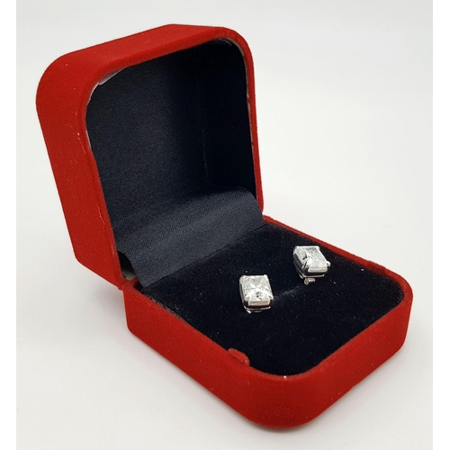 948 - A pair of 925 silver stud earrings set with radiant-cut white moissanite stones. Total weight: 2.9g.... 