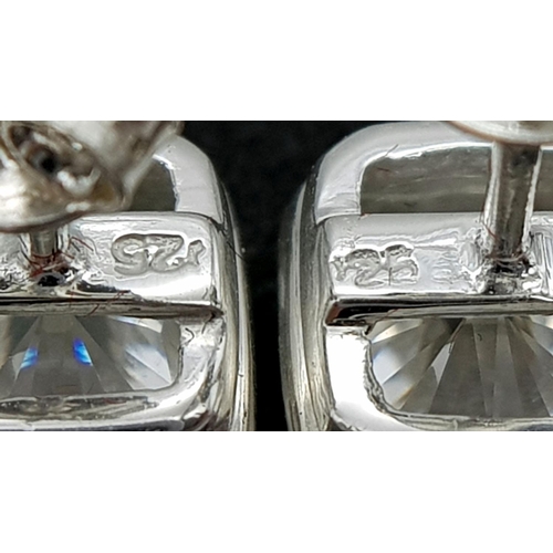 948 - A pair of 925 silver stud earrings set with radiant-cut white moissanite stones. Total weight: 2.9g.... 