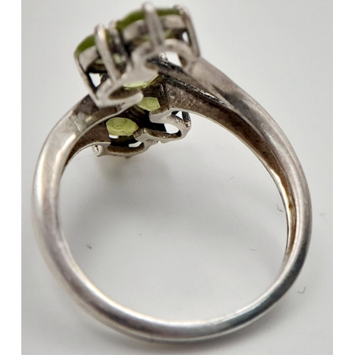 985 - A Sterling Silver and Peridot Set Five Stone Statement Ring Size R. Set with Five 5mm Long Oval Cut ... 