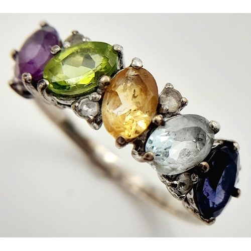 999 - A Sterling Silver Multi-Gemstone Set Ring Size P. The Ring is set with Oval and Round Cut Blue ands ... 