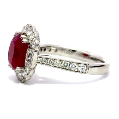 514 - A Platinum RUBY and DIAMOND Cluster Ring. 3.54ct claw set oval shape Ruby centre, decorated with 0.7... 