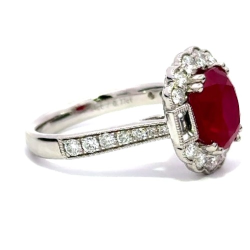 514 - A Platinum RUBY and DIAMOND Cluster Ring. 3.54ct claw set oval shape Ruby centre, decorated with 0.7... 