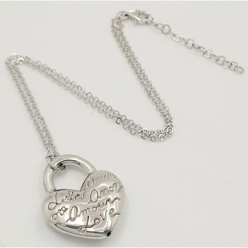 1052 - A STERLING SILVER NECKLACE WITH HEART PENDANT ENGRAVED WITH THE WORD LOVE IN MANY LANGUAGES 9.8G. Re... 