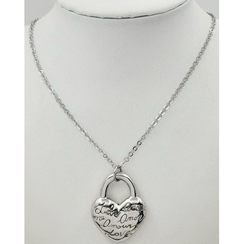 1052 - A STERLING SILVER NECKLACE WITH HEART PENDANT ENGRAVED WITH THE WORD LOVE IN MANY LANGUAGES 9.8G. Re... 