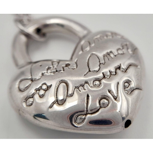 1052 - A STERLING SILVER NECKLACE WITH HEART PENDANT ENGRAVED WITH THE WORD LOVE IN MANY LANGUAGES 9.8G. Re... 