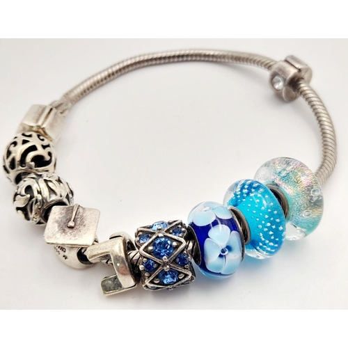 1076 - Sterling Silver Charm Bracelet including Charms from Swarovski, Pandora etc. 38.66 Grams.