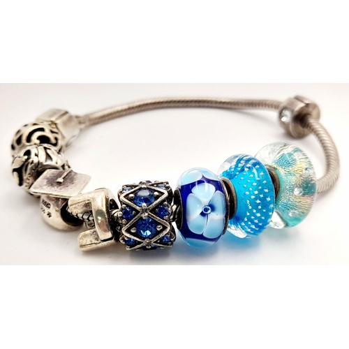 1076 - Sterling Silver Charm Bracelet including Charms from Swarovski, Pandora etc. 38.66 Grams.