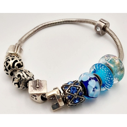 1076 - Sterling Silver Charm Bracelet including Charms from Swarovski, Pandora etc. 38.66 Grams.