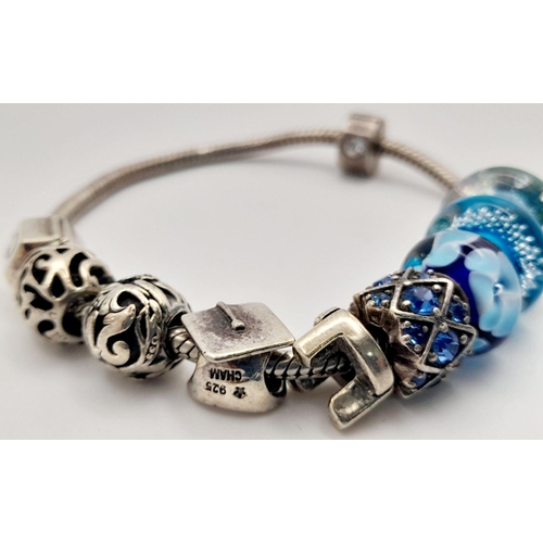 1076 - Sterling Silver Charm Bracelet including Charms from Swarovski, Pandora etc. 38.66 Grams.