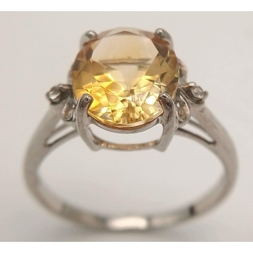 1140 - A Sterling Silver Citrine and White Sapphire Set Ring Size T. The Ring is set with a 1.2cm Long Oval... 