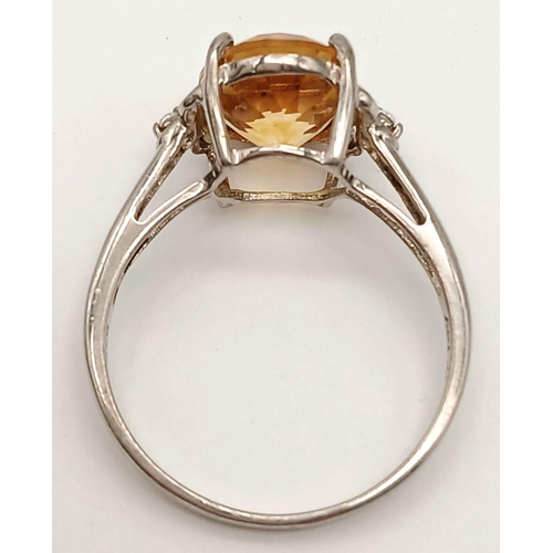 1140 - A Sterling Silver Citrine and White Sapphire Set Ring Size T. The Ring is set with a 1.2cm Long Oval... 