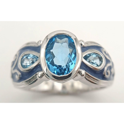 1154 - A Sterling Silver. Blue Topaz and Enamel Ring Size X. The Ring is set with a 1cm Long Centre Blue To... 