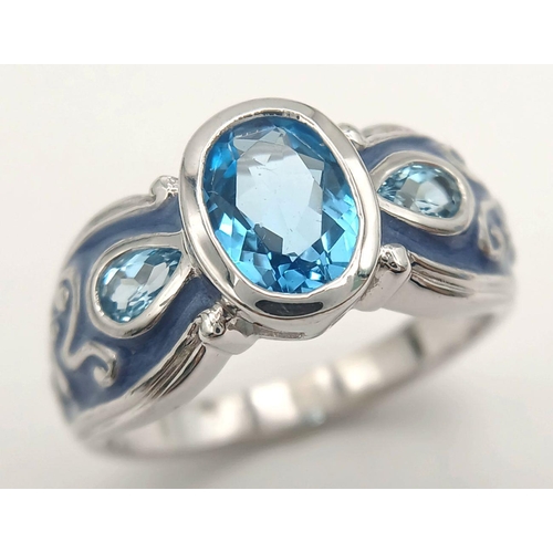 1154 - A Sterling Silver. Blue Topaz and Enamel Ring Size X. The Ring is set with a 1cm Long Centre Blue To... 